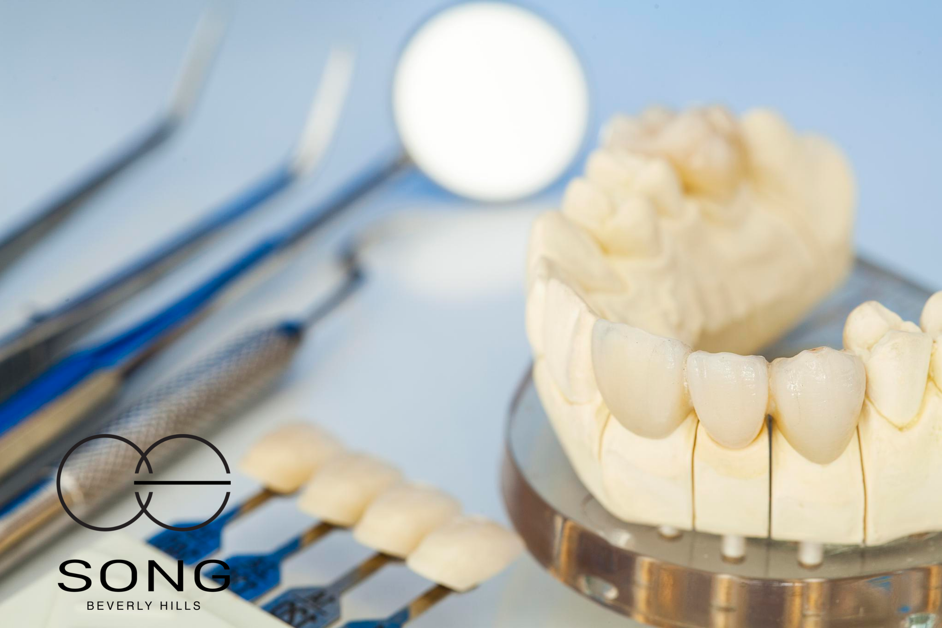 An image of porcelain veneers and dental tools